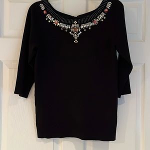 Black sweater with jeweled neckline, satin bow in back and 3/4 length sleeves.